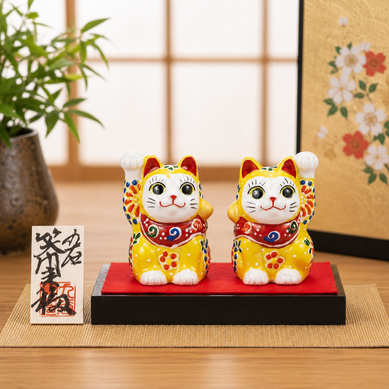 KUTANI WARE PAIR MANEKI NEKO – LUCKY CAT FIGURINES WITH YELLOW EMBELLISHMENT, DISPLAY STAND, CLOTH, AND NAMEPLATE